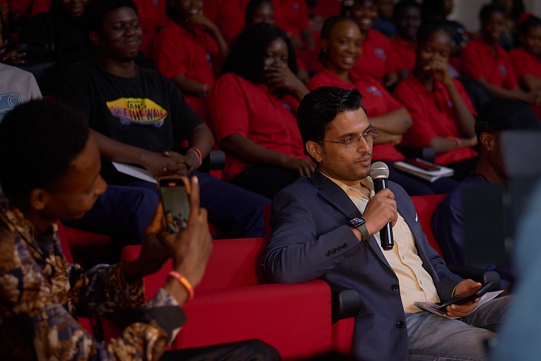 A speaker seated among students at an IDAN session